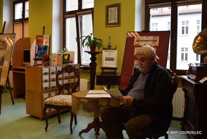 Uczestnik spotkania Dyskusyjnego Klubu Książki w Czytelni MBP czyta wiersze.