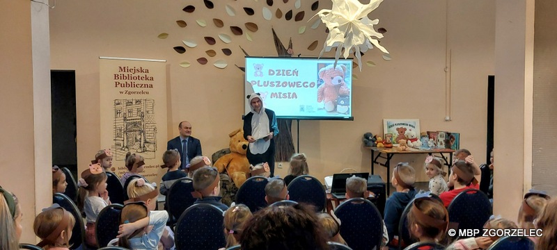 W pomiesczeniu Miejskiego Klubu Seniora w Zgorzelcu jest Pan burmistrz Miasta Zgorzelec - Rafał Gronicz, bibliotekarz w stroju pandy i grupa przedszkolaków. 