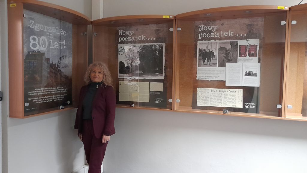 Dyrektor MBP Krystyna Radzięta, w tle plansze wystawy “Zgorzelec ma 80 lat!” prezentowanej w Dolnośląskiej Bibliotece Publicznej we Wrocławiu. Zdjęcie jest odnośnikiem do wpisu o wystawie 