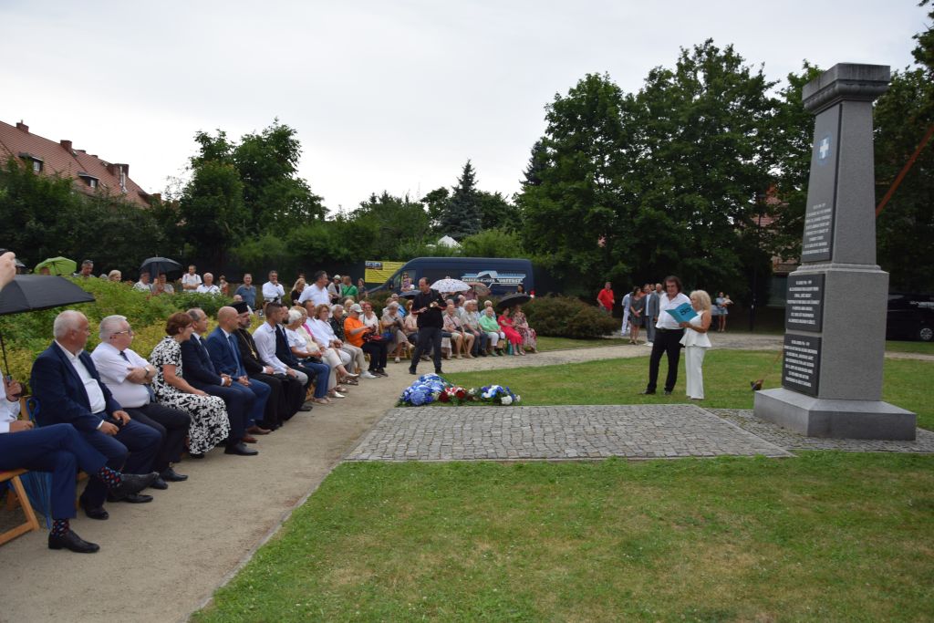 Dyrektor Międzynarodowego Festiwalu Piosenki Greckiej Nikos Rusketos oraz Dyrektor Miejskiej Biblioteki Publicznej Krystyna Radzięta zapowiadają koncert greckiego wirtuoza bouzouki Angelo Wangelisa z zespołem podczas uroczystości przy obelisku w Parku im. Ignacego Paderewskiego w Zgorzelcu. Zdjęcie jest odnośnikiem do relacji z koncertu.