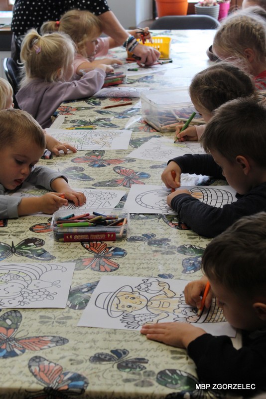 Uczestnicy zajęć bibliotecznych kolorują przygotowane ilustracje warzyw, korzystając z&nbsp;kredek i&nbsp;materiałów plastycznych.